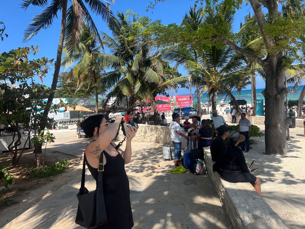Elise taking photos by the beach